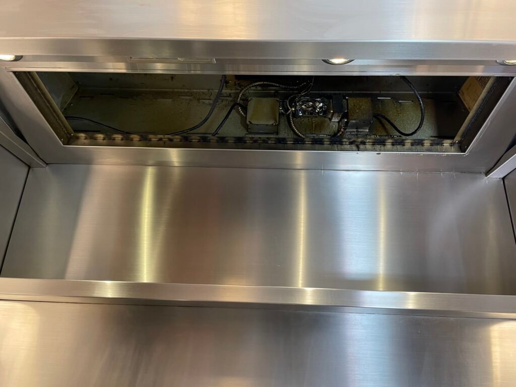 Viking professional range hood disassembled with filters removed, heavy grease accumulation visible