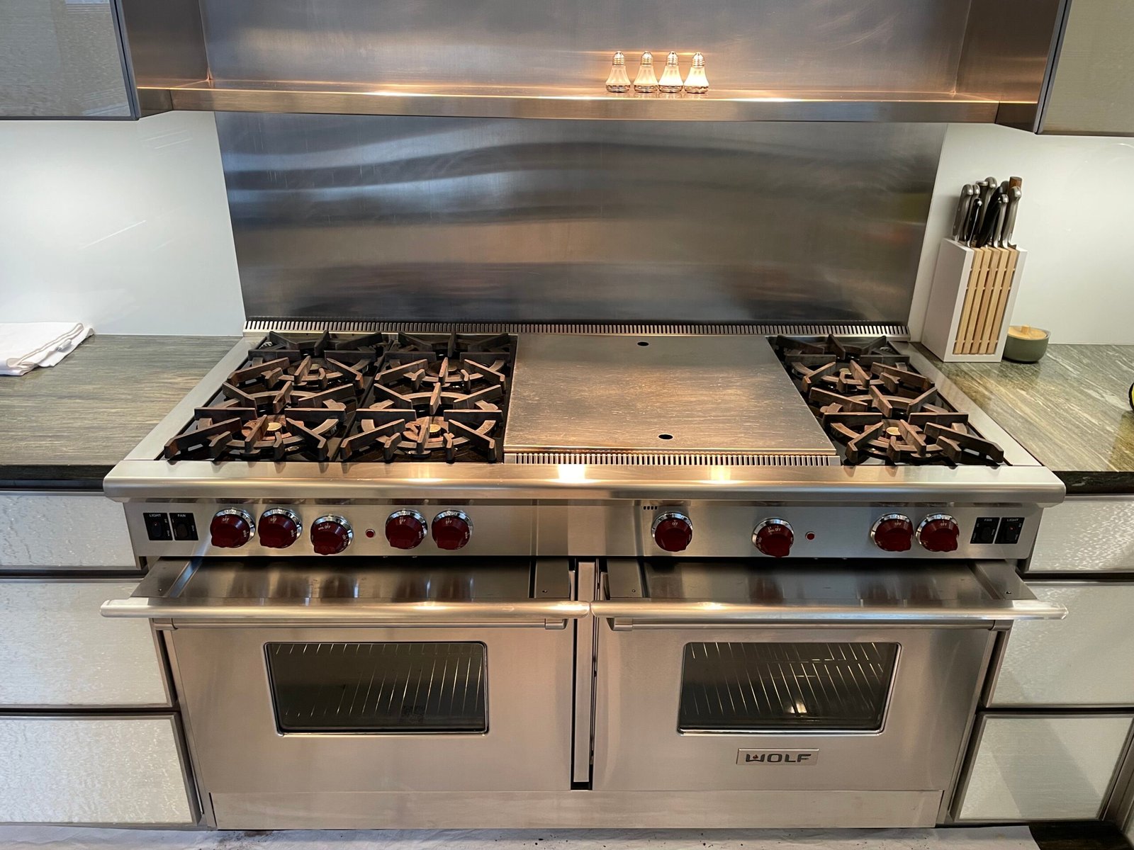 Professional deep cleaning of Wolf cooking range — grease removed, broiler and racks polished, interior fully refreshed