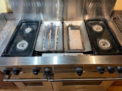 High-end Wolf range with 4 burners, built-in grill and griddle removed, prepared for precision restoration