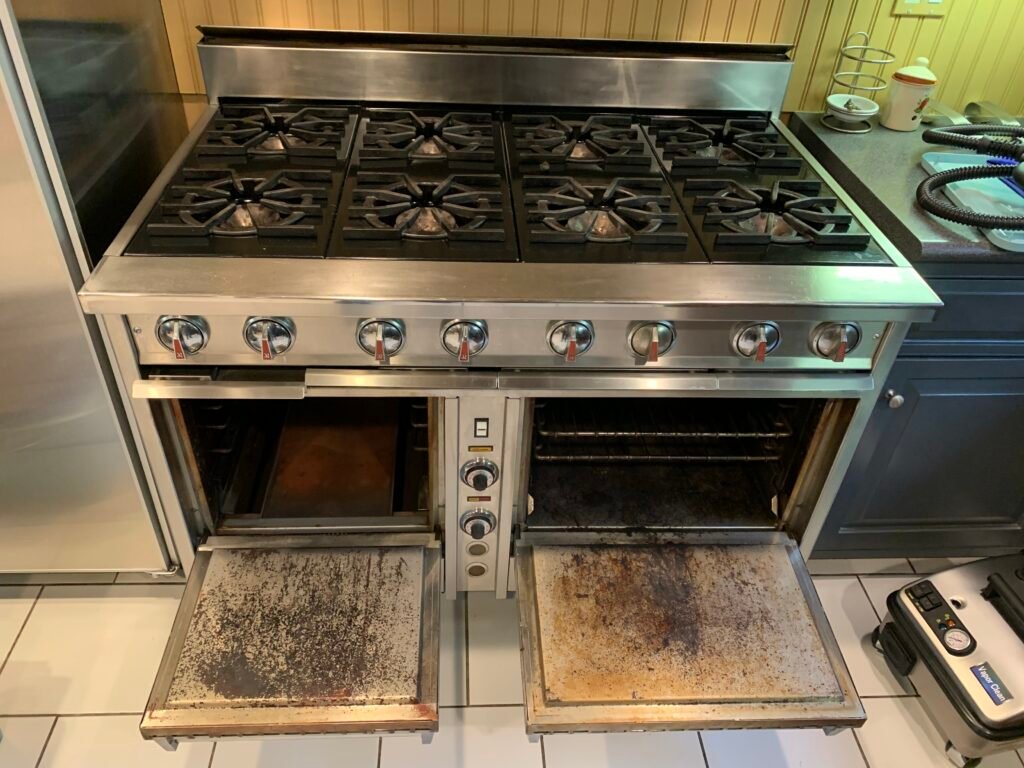 Side‑by‑side comparison of a Dynasty Cooking Range before professional deep cleaning by OvenPal, showing extreme buildup of grease, grime, and residue.