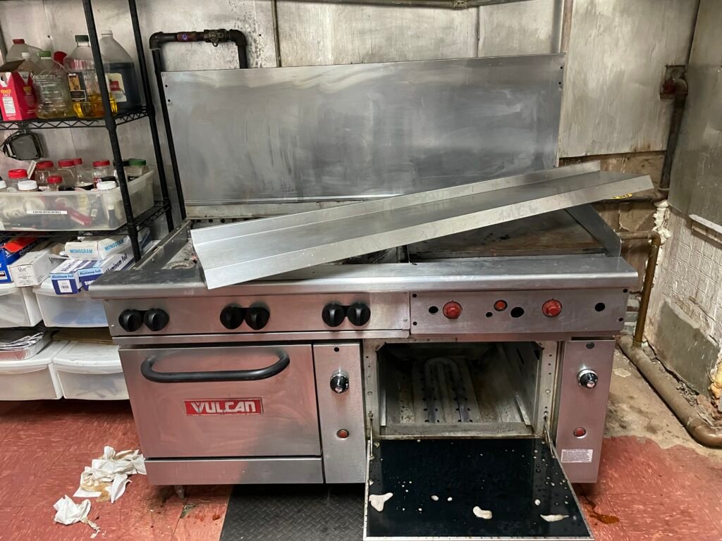 Neglected Vulcan commercial range awaiting significant cleaning and restoration for safe kitchen use