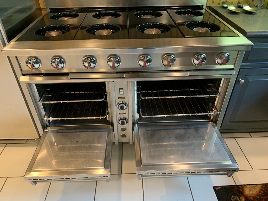 Luxury Dynasty 6-burner range with double oven, restored shine after professional deep cleaning