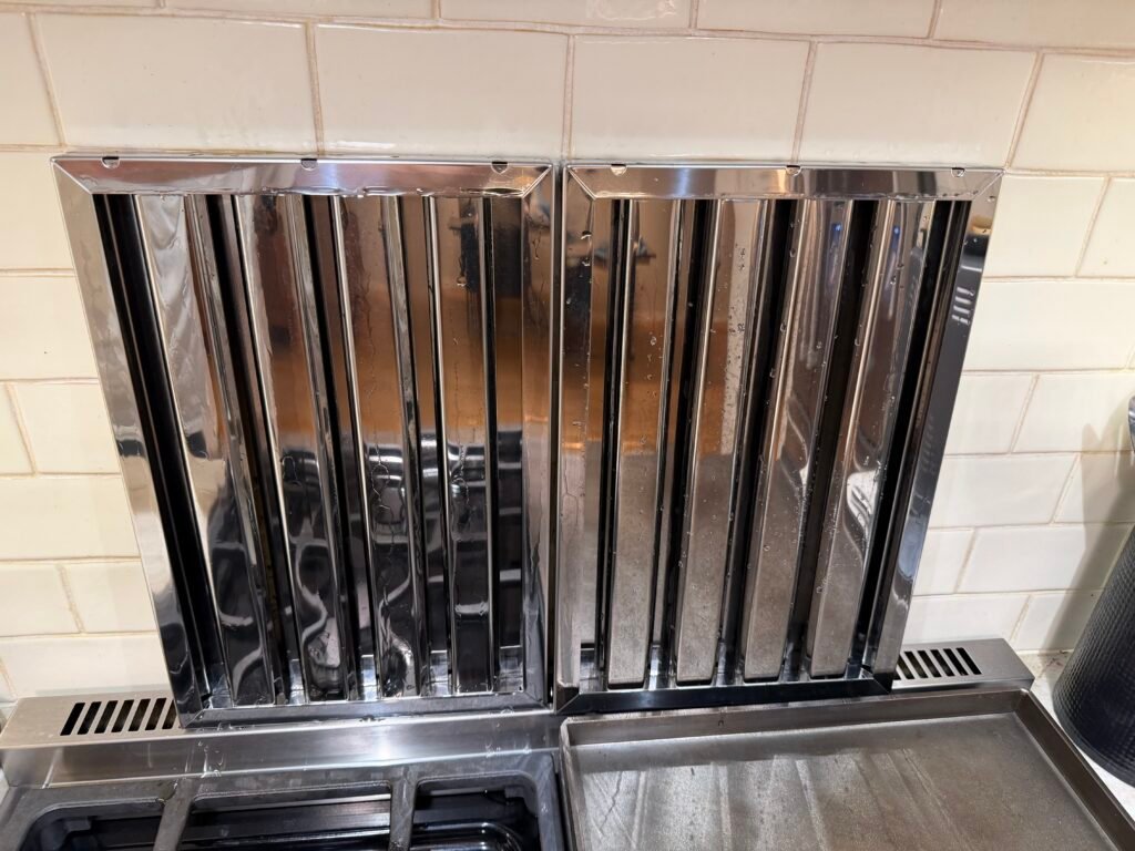 Miele range hood with filters removed, polished, and shined during professional deep cleaning