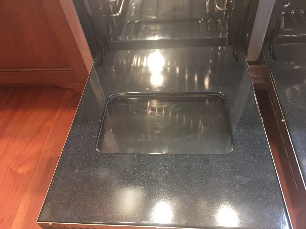 Baked on grease removal from oven door and glass after OvenPal's signature cooking range deep cleaning .
