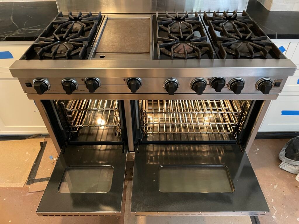 High-end Viking range with double oven, six burners, and griddle, stainless steel surface polished to shine