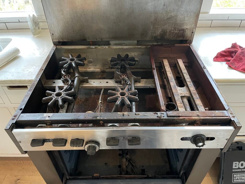 Garland professional range with broiler and built-in backsplash, stainless steel finish