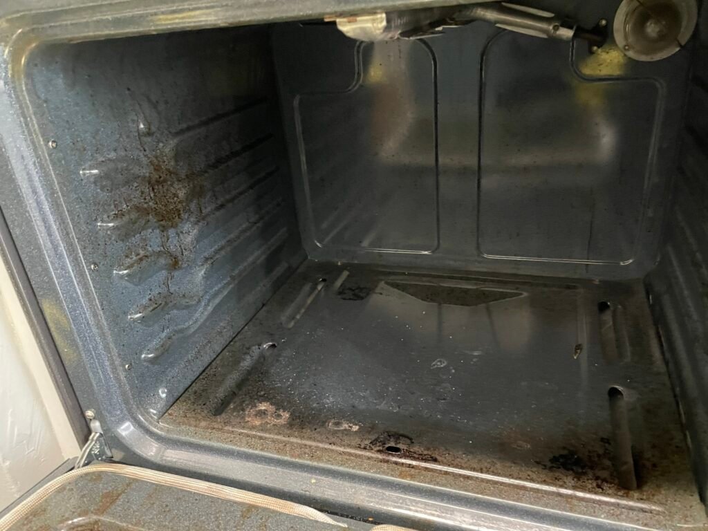 Grease-coated interior of a KitchenAid oven before professional deep cleaning service.