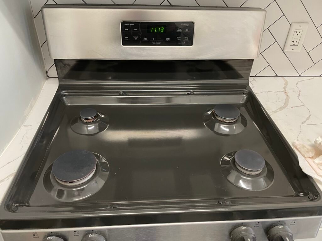 KitchenAid oven top with burners restored to mirror perfection after professional deep cleaning service