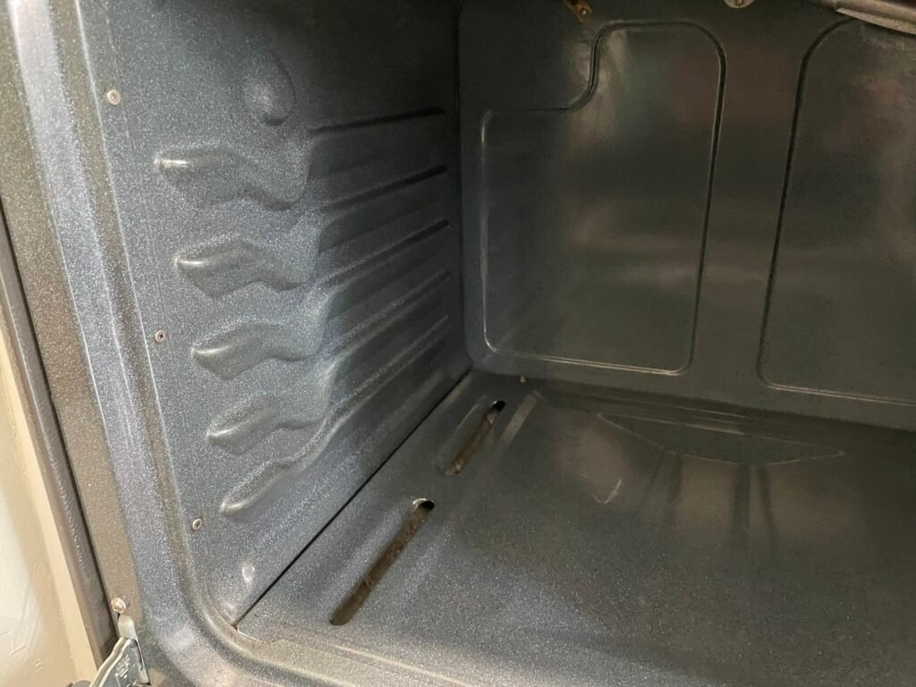 Grease-free KitchenAid oven interior showcasing results of professional deep cleaning and detailing.