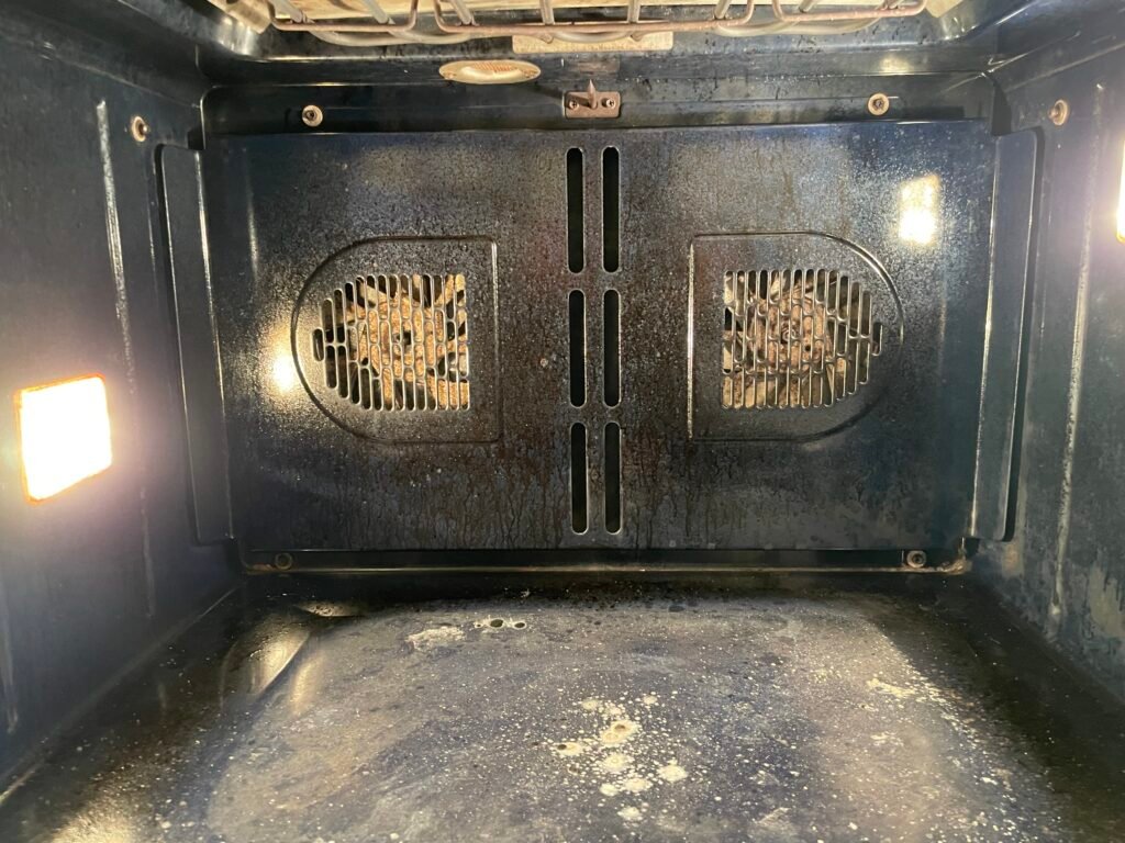 Grease‑covered Wolf gas range before professional deep cleaning and detailing service