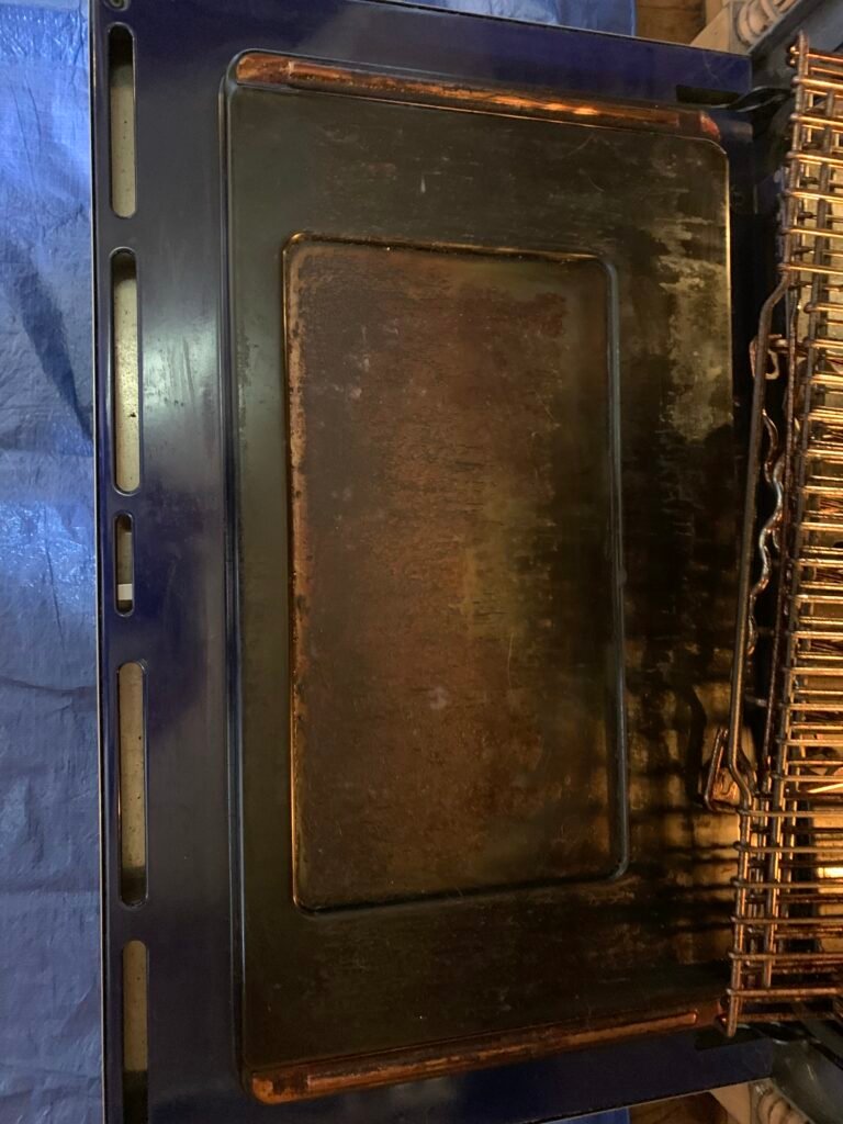Grease‑covered interior of a Wolf built‑in oven before professional deep cleaning and detailing service.