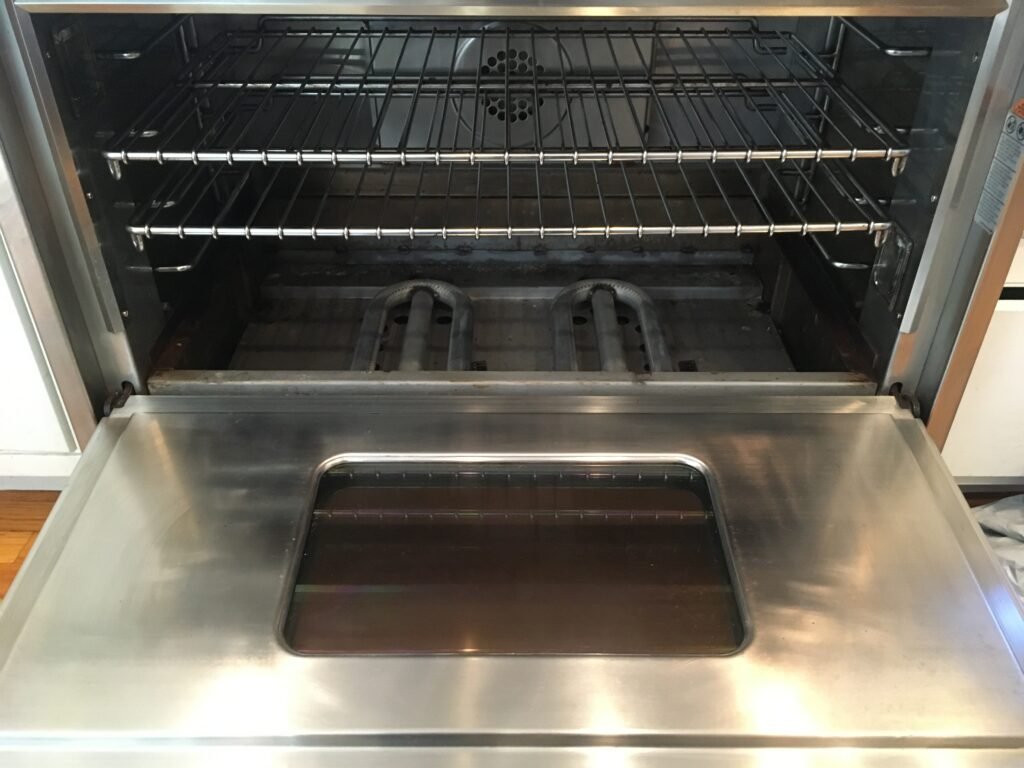 Side‑by‑side comparison of a Kenmore Cooking Range after professional deep cleaning by OvenPal, showing removal of grease, grime, and residue with restored shine and performance.