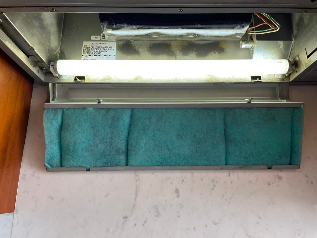 Filter mesh replacement on Miele range hood showing restored airflow during professional cleaning