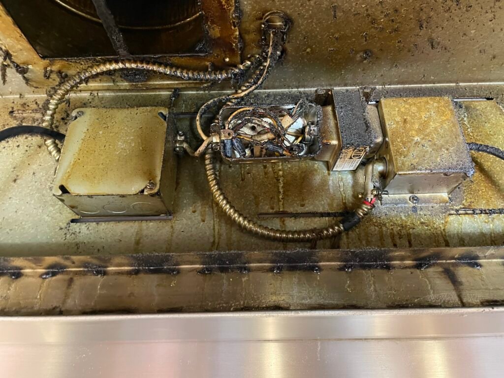 48-inch Viking range hood with heavy grease buildup covering wiring and blower motor during deep cleaning