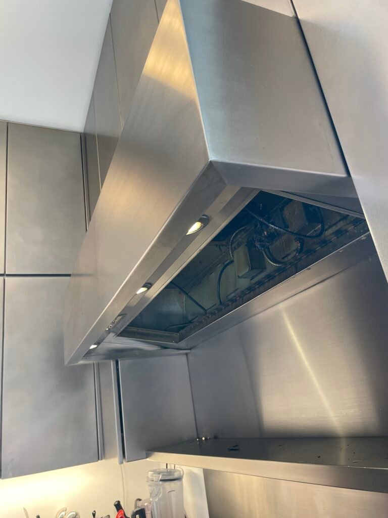 Luxury Viking stainless steel hood backsplash and warming shelf before being restored during professional deep cleaning