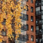Brick apartment building surrounded by fall colors in Westchester County, representing OvenPal’s expert oven deep cleaning services, professional appliance cleaning, and high‑end kitchen appliance care for homes throughout Westchester.