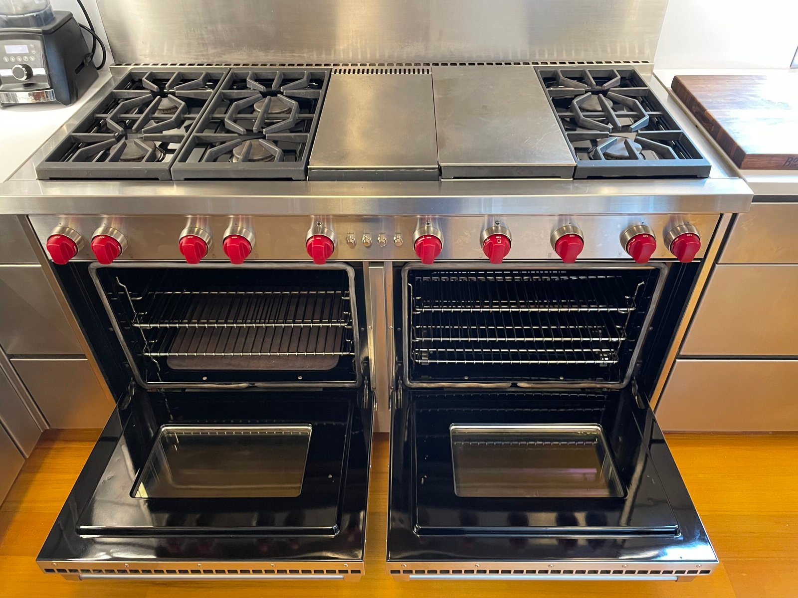 A fully restored Wolf double-oven gas range with integrated griddle in a Manhattan kitchen, showcasing the results of OvenPal NYC’s deep cleaning and carbon removal protocol for luxury appliances.