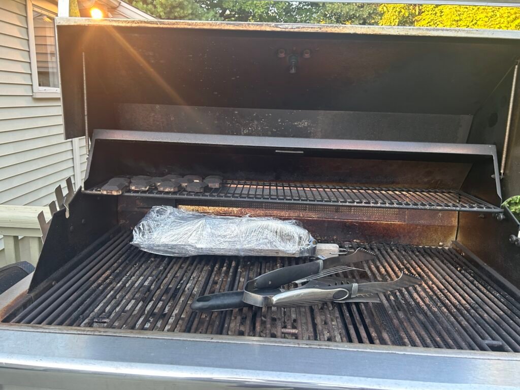 This Lynx outdoor grill showed heavy carbon buildup on the grates, residue around the rotisserie infrared burner, and darkened ceramic briquettes — typical of Tribeca terraces and SoHo rooftop kitchens where grills see year‑round use.