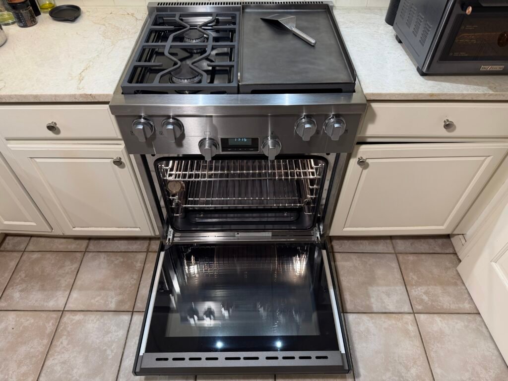 NYC luxury appliance cleaning technician completing final detailing on a Miele gas range with showroom‑level exterior polishing, full functionality testing, workspace cleanup, and an on‑site client review of restored performance